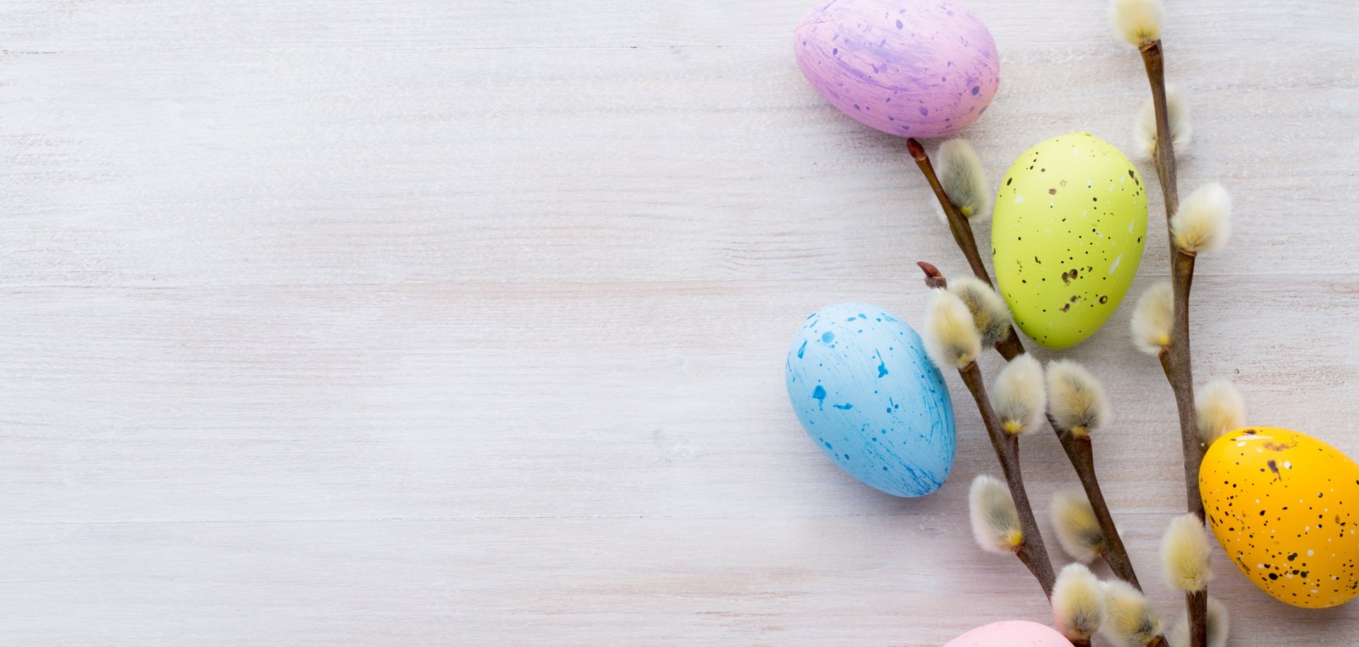 Easter and spring decorations Symbolic Easter decoration with willow catkins and five eggs dyed in different colours.