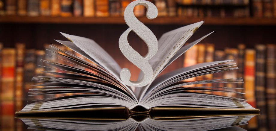 Legislation - Paragraph Paragraph in an open book in a library.