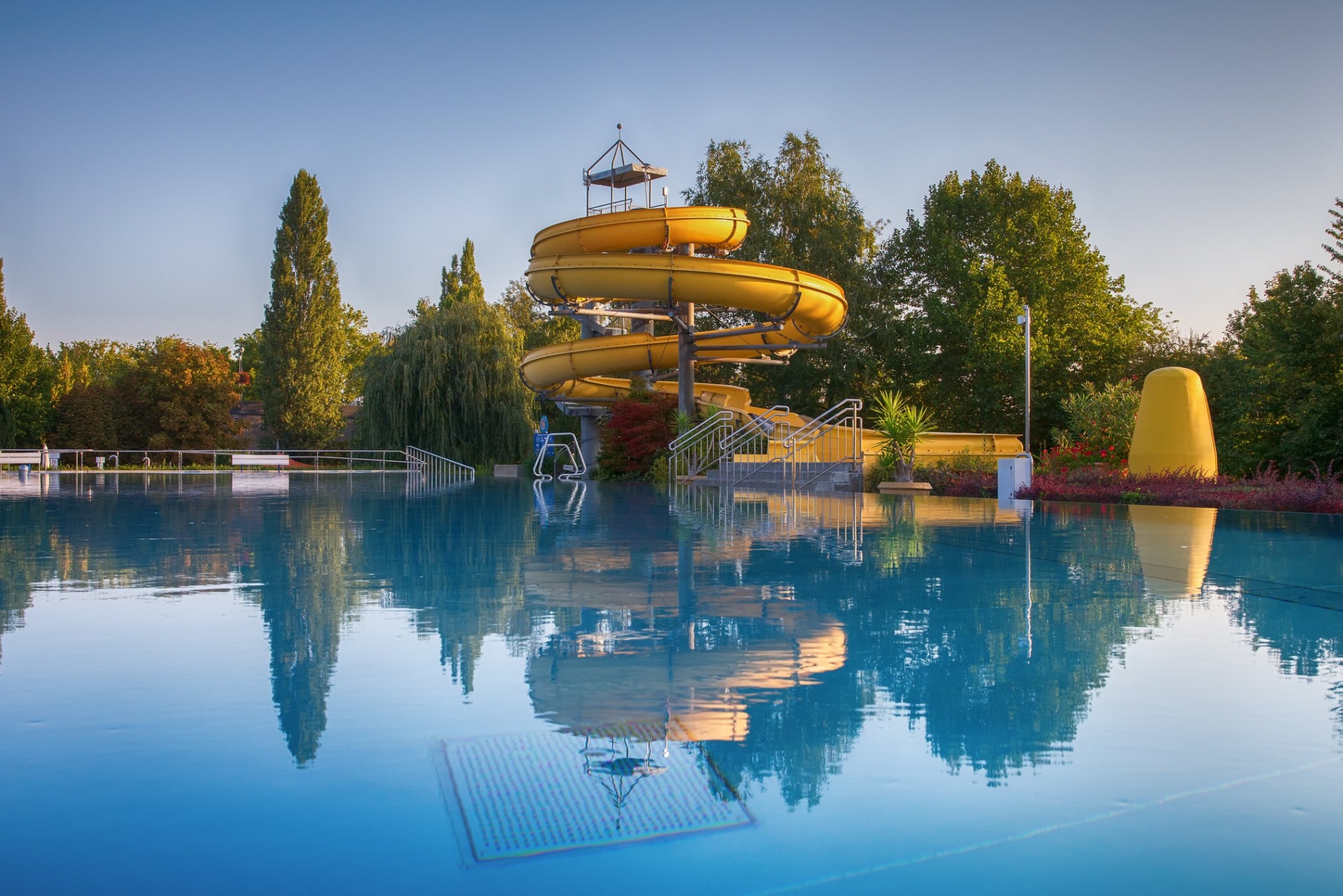 View of the yellow water slide in the outdoor pool on Mondsee Island.