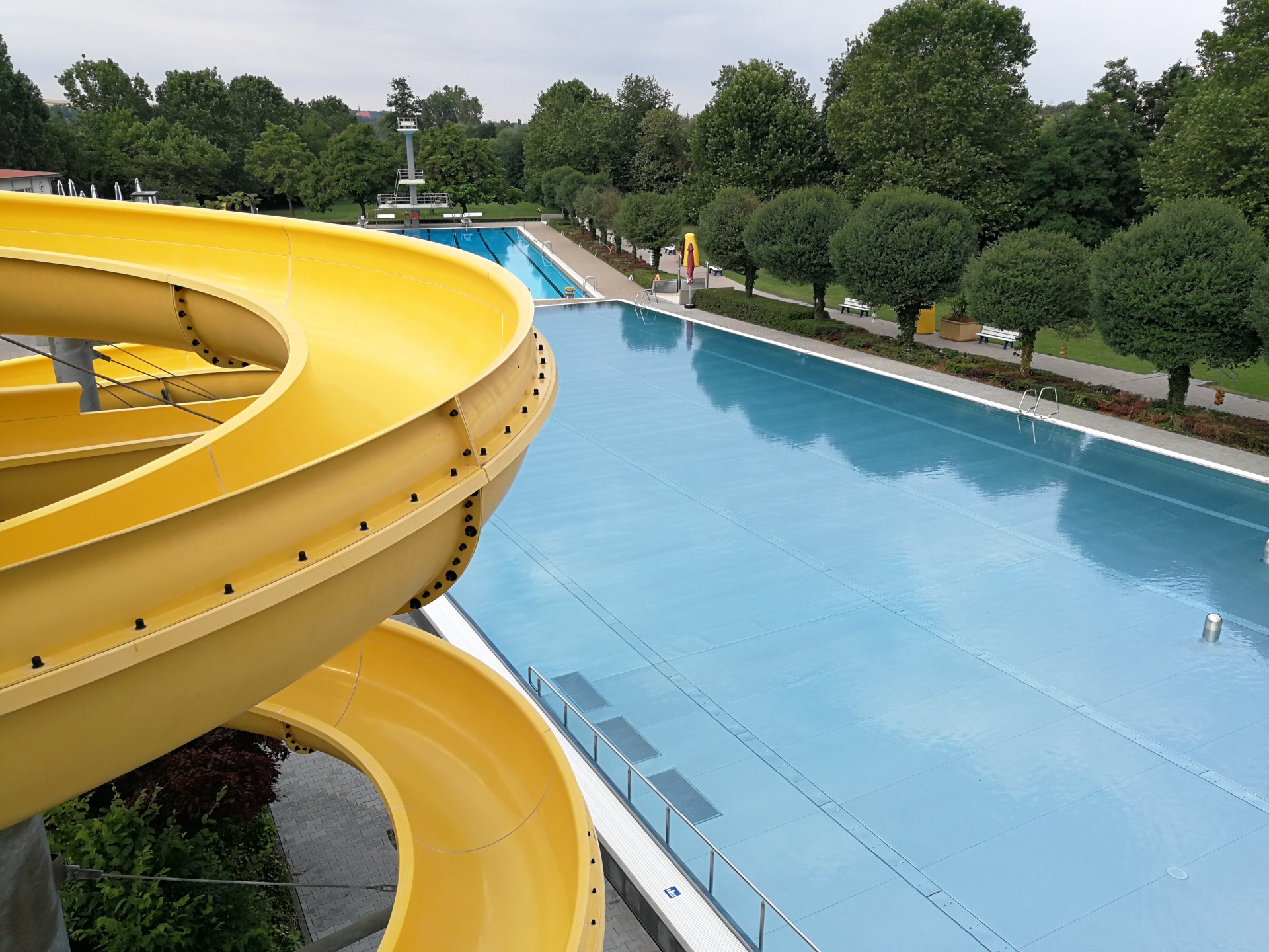 Outdoor pool Mondseeinsel Blick auf die Schwimmbecken vom Freibad von der Rutsche aus.