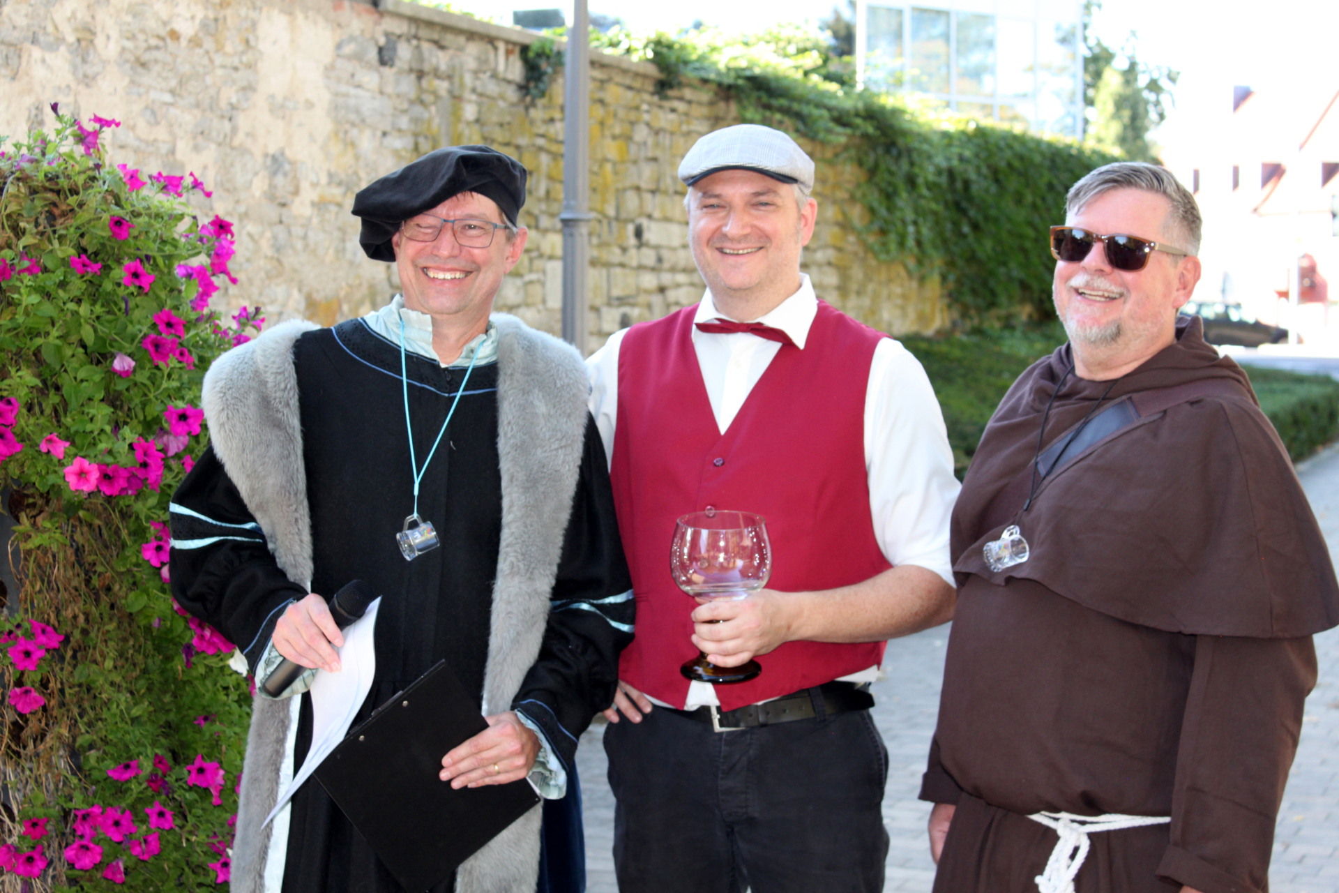 Three disguised men laugh into the camera