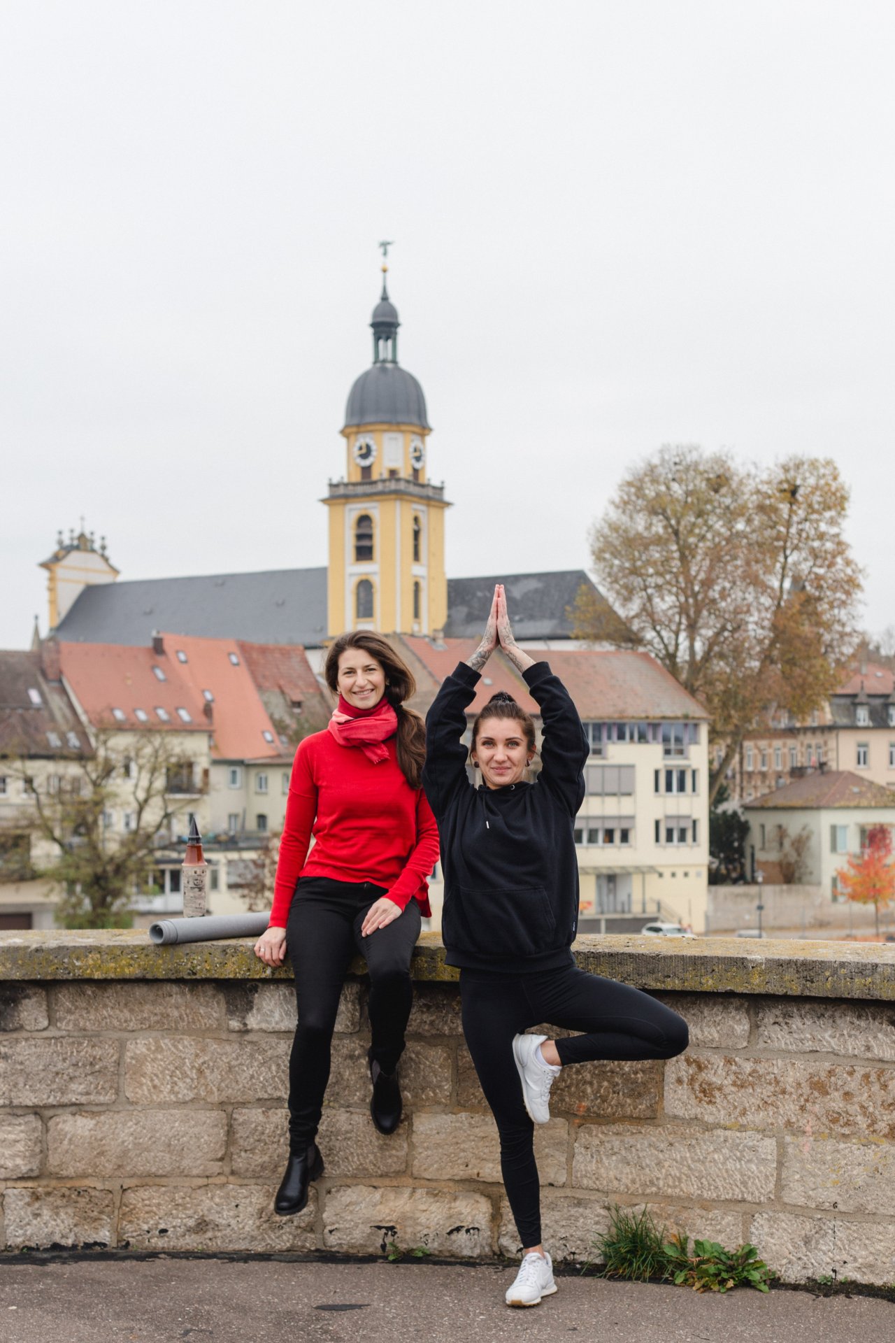 Yoga city tour Two women on the Old Main Bridge, one of them making a figure from yoga