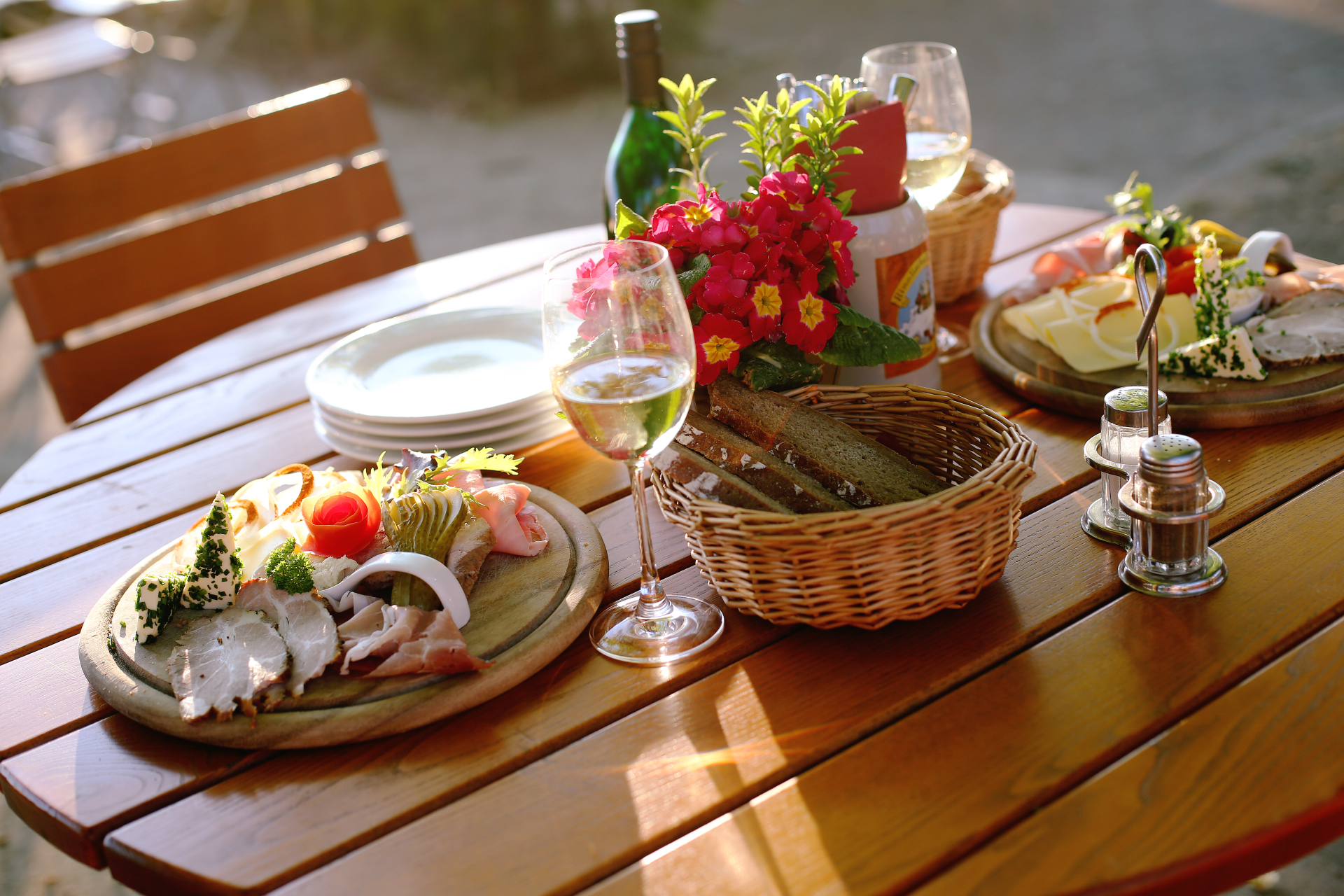 Table set with sausage platter, bread and wine
