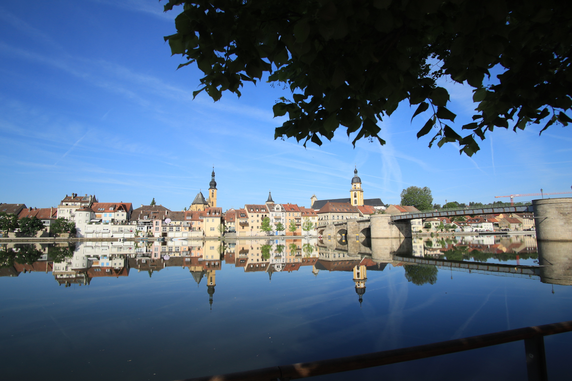 City panorama reflection View of Kitzingen from the town balcony in summer, with the Alte Mainblicke on the right. The silhouette of the town is reflected in the Main