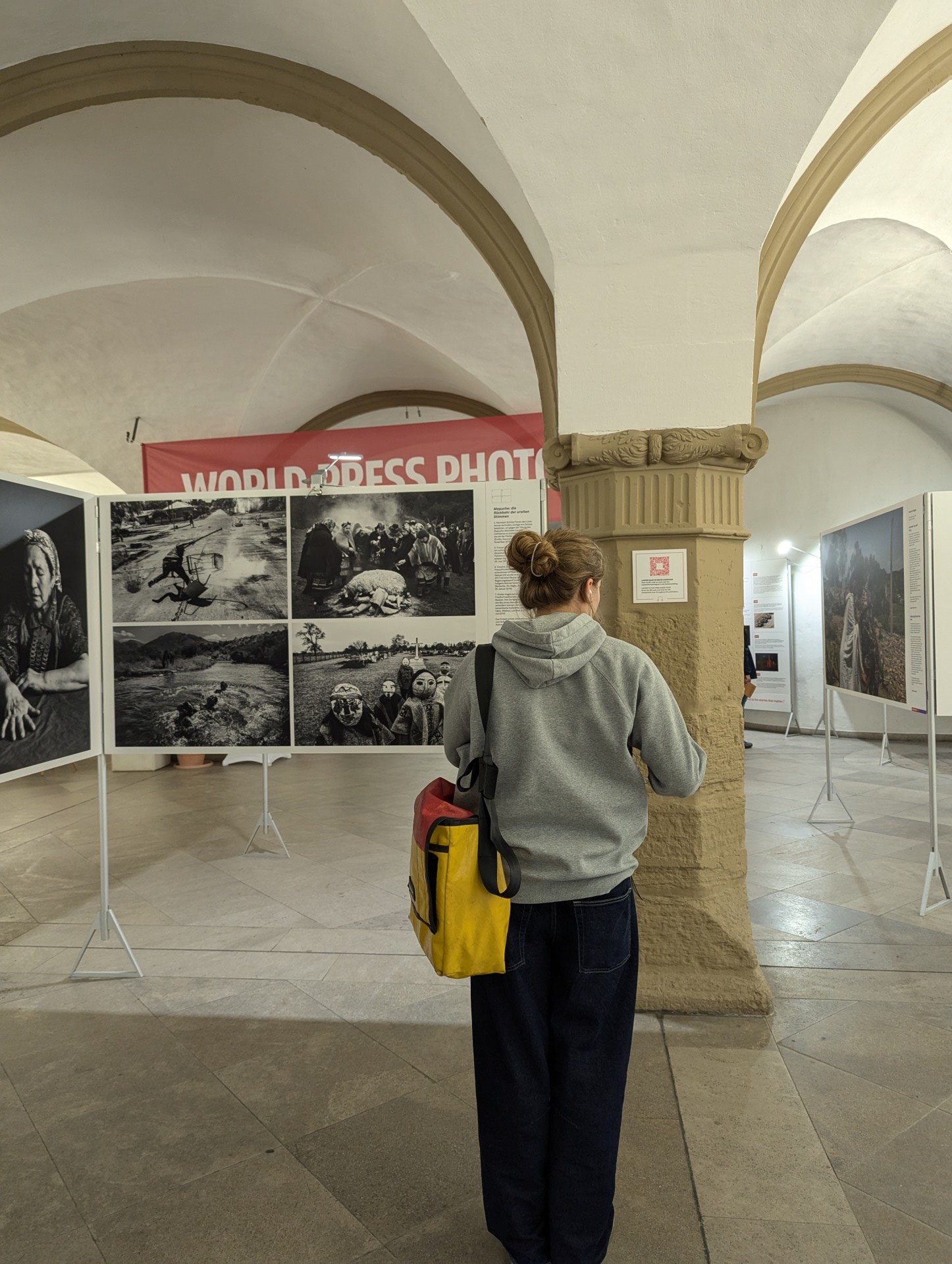 A woman stands in front of a picture