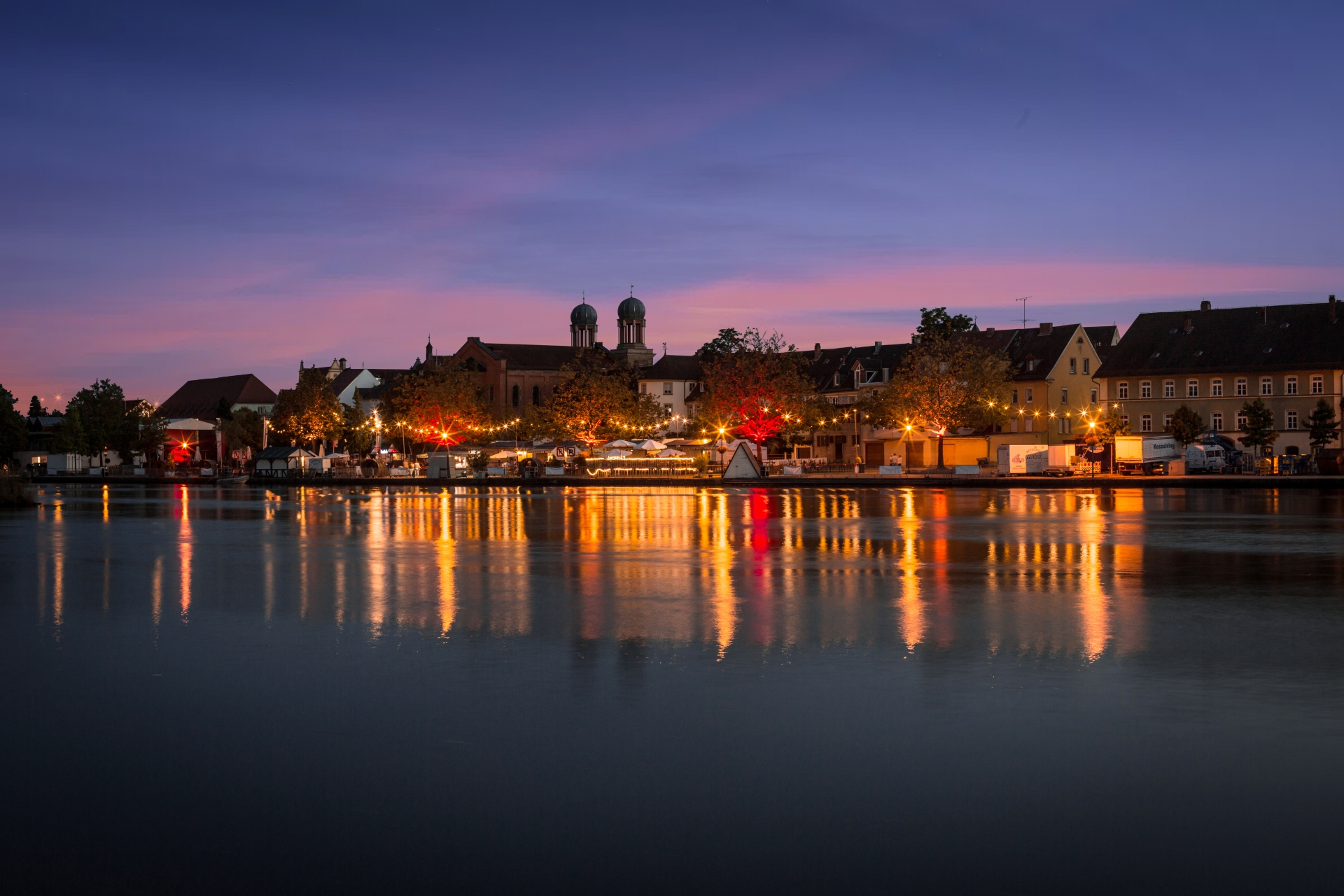 Wine festival panorama in the sunset View of the Kitzingen Promenade Wine Festival in the evening
